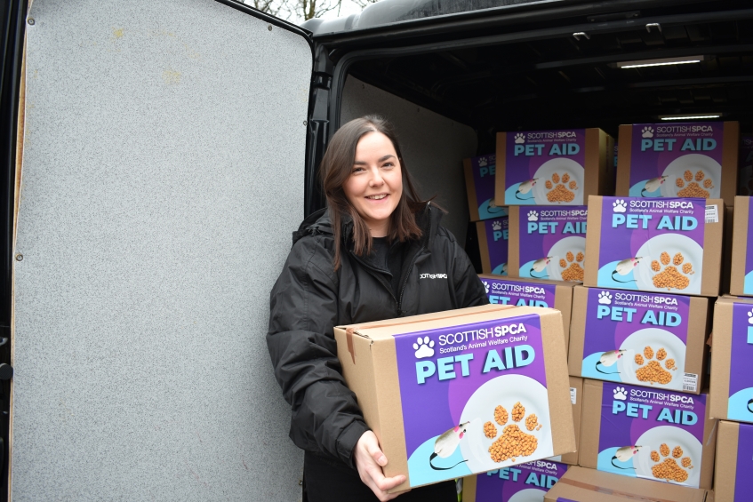 a scottish spca member of staff delivering pet aid food boxes