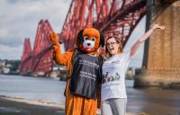 2 staff members standing in front of the Forth Bridge