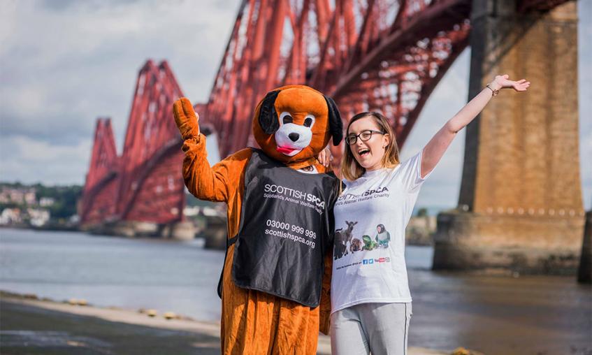 2 staff members standing in front of the Forth Bridge