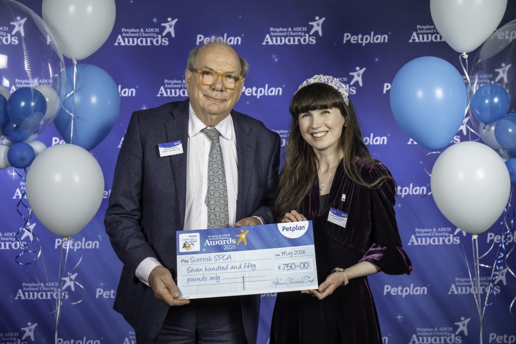 Volunteer of the year receiving cheque from Pet Plan chair and co-founder